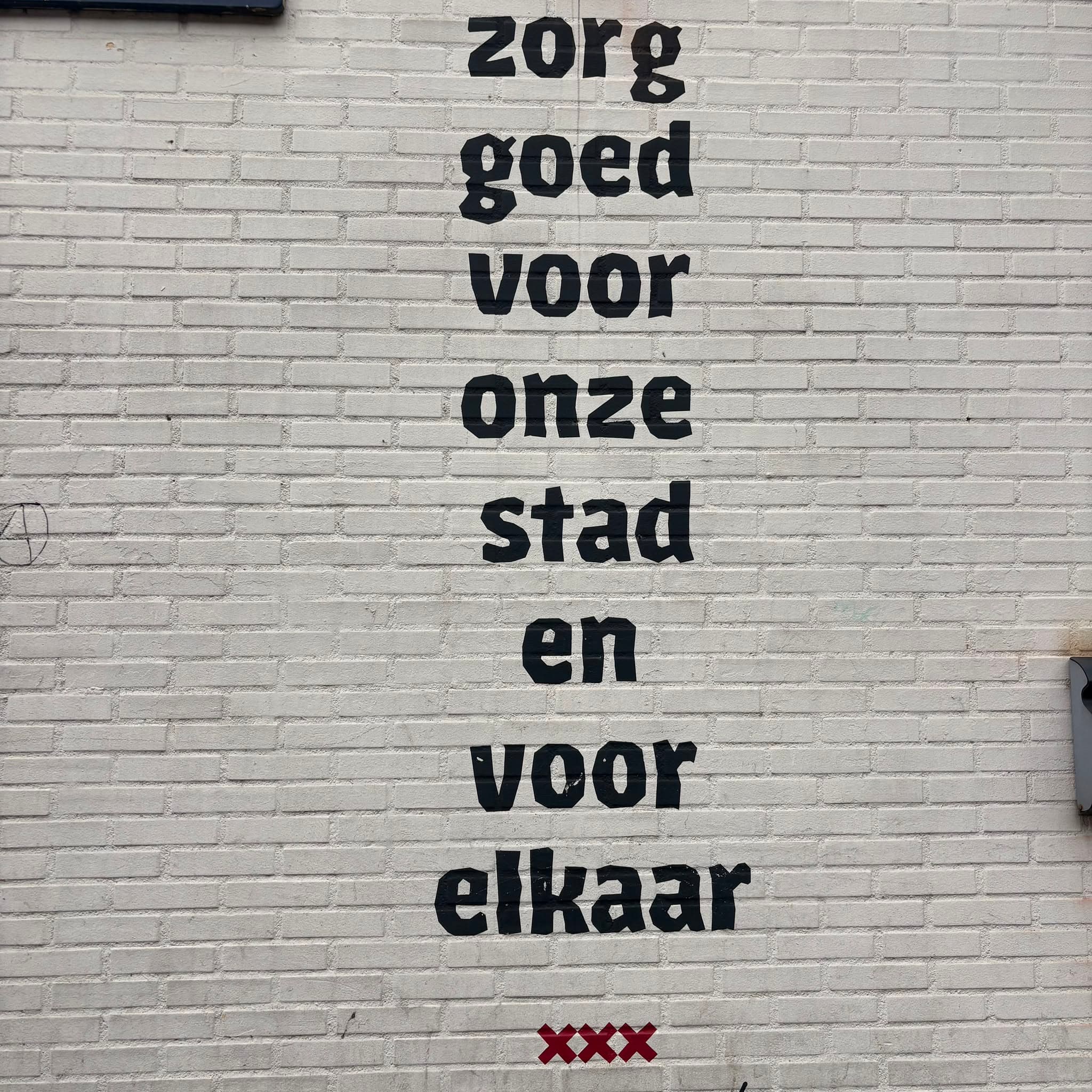 Wall text in Amsterdam: take good care of our city and of each other